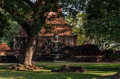 Thailand, Old Sukhothai - Wat Mahathat, square-based, multi-layered chedi with statues of seated Buddha at each side. 